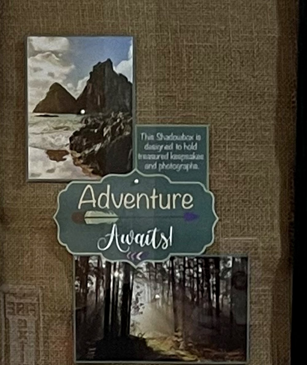 Inside one resident's shadow box: photographs pinned to burlap, with a card that reads Adventure Awaits.
